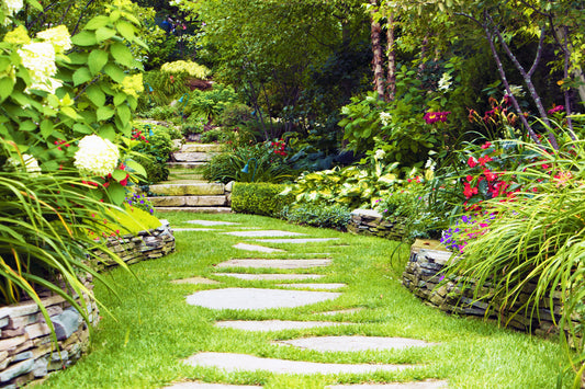 A flagstone path meanders into a private cottage garden on Mackinac Island, beckoning viewers to take time to enjoy the nature around them.  The tranquil setting evokes a sense of calm.