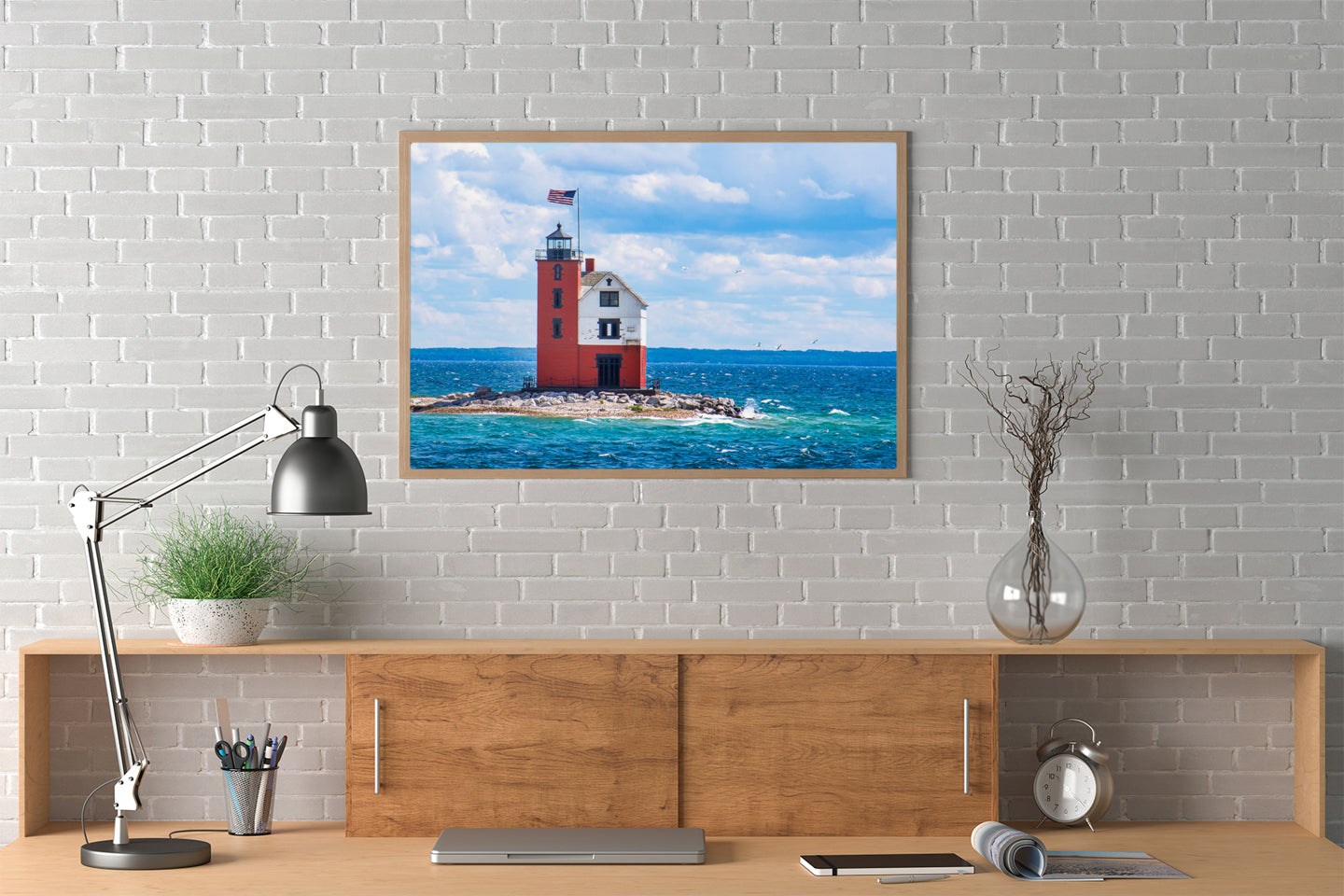 Round Island Lighthouse photograph by Jennifer Wohletz of Mackinac Memories. The USA flag flies over Round Island Lighthouse across the channel from Mackinac Island. The lighthouse serves as the finish line for sailing races starting from Chicago and Bayview Yacht Clubs each summer.Round Island Lighthouse photograph by Jennifer Wohletz of Mackinac Memories. T