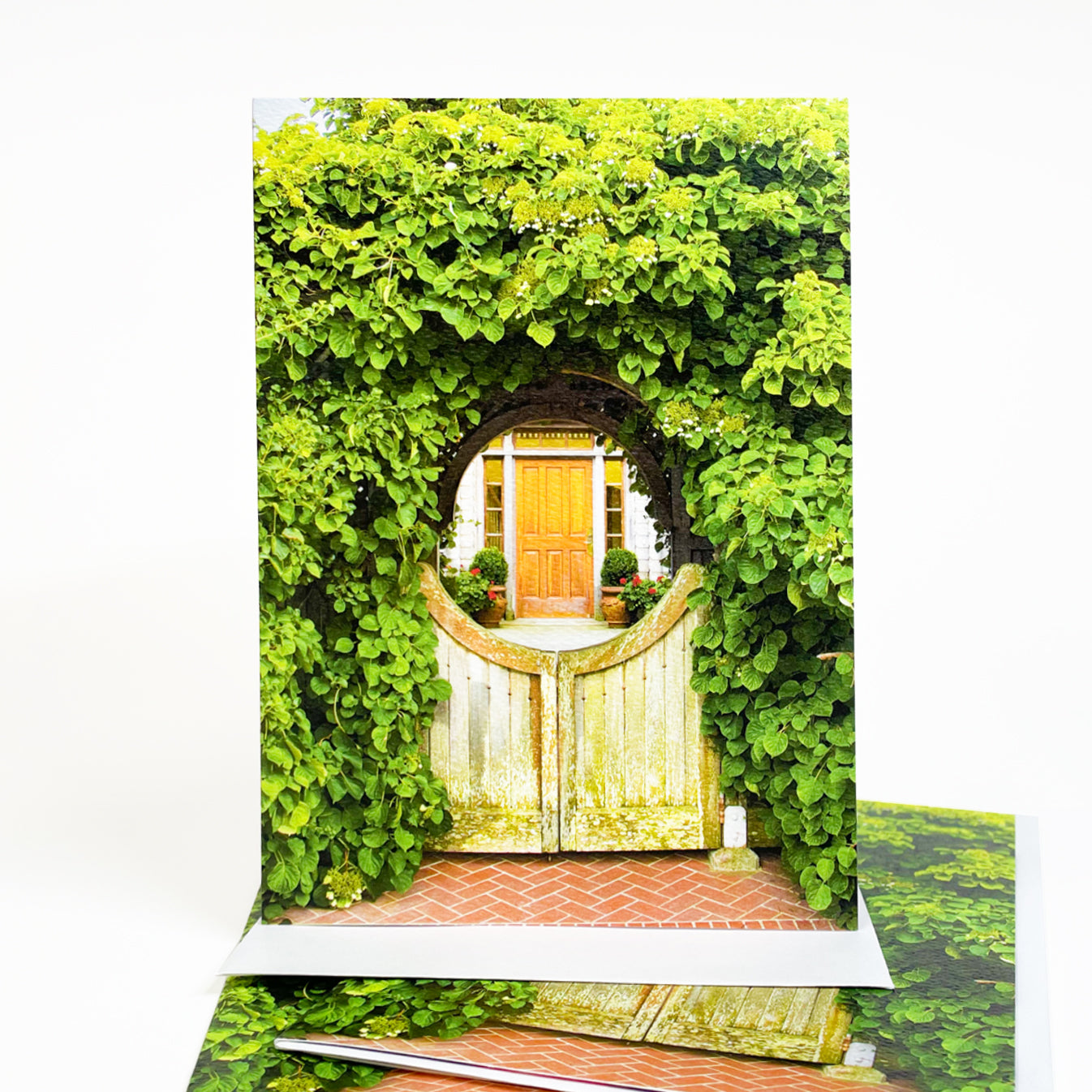 Blank greeting card featuring a photograph of a Mackinac Island cottage gate covered in geranium blooms by Michigan artist Jennifer Wohletz of Mackinac Memories.