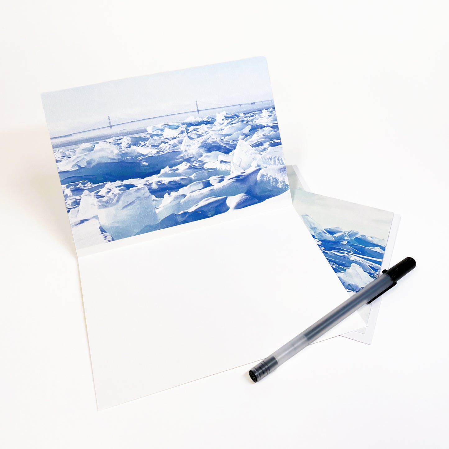 Blank greeting card featuring a photograph featuring a view of Round Island Lighthouse behind a wall of blue ice by local artist Jennifer Wohletz of Mackinac Memories.