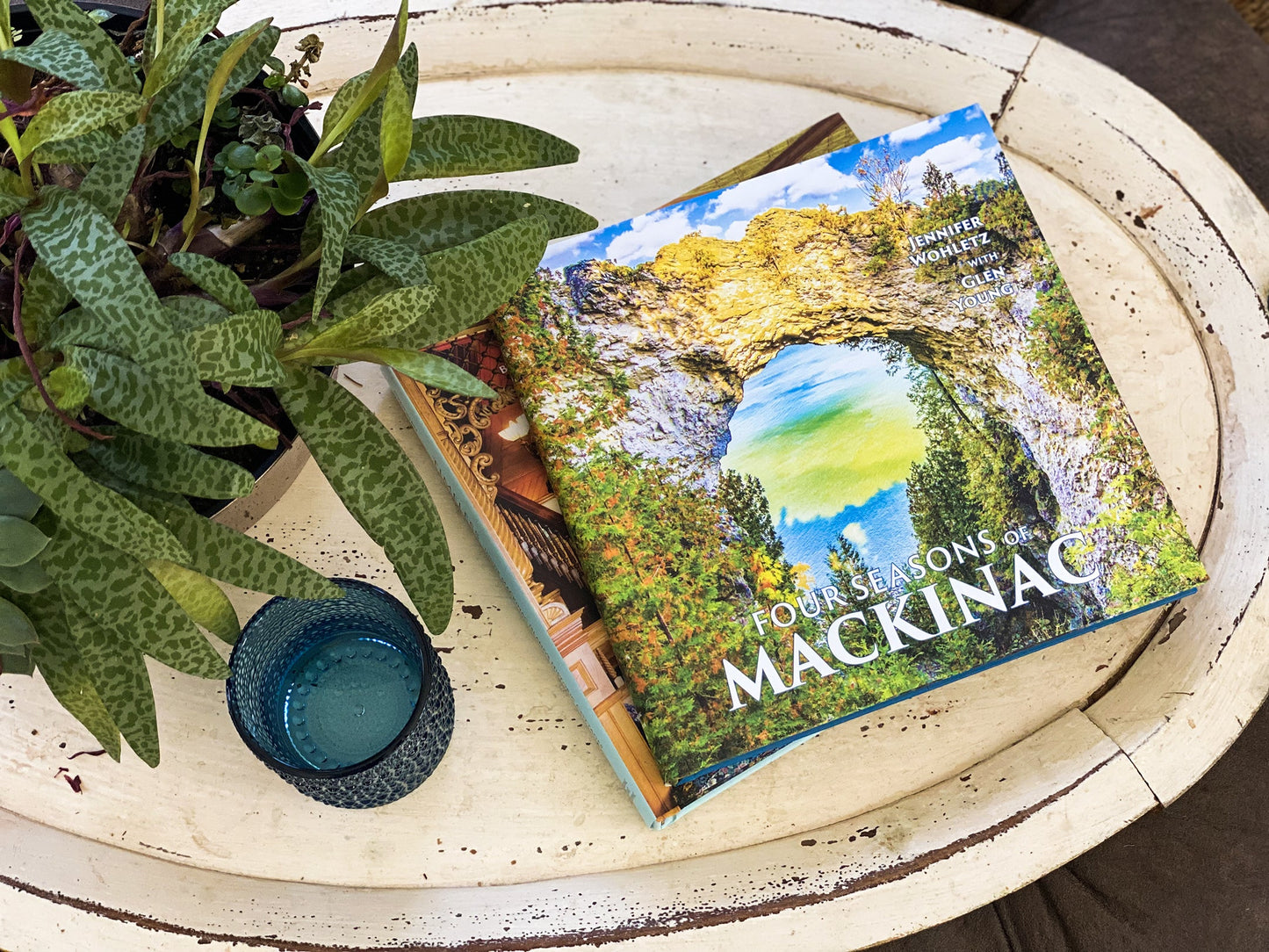 Four Seasons of Mackinac coffee table book by Jennifer Wohletz & Glen Young. Published by Mackinac Memories 184-pages, hard cover with a dust jacket. A photoessay by Jennifer Wohletz with text by Glen Young. Contributing photographers include: Jennifer Wohletz, Mark Bearss, Kara Beth Nicholson, Mark Sawatzki, Jimmy Taylor, Katharine Rose Witt and Sara Wright.