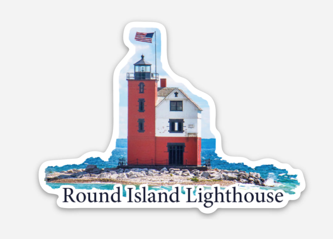 This die cut vinyl sticker features a photo of Round Island Lighthouse with the American flag waving on a beautiful sunny day.  The lighthouse is located near Mackinac Island, Mich.