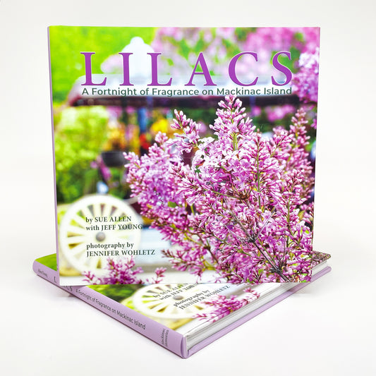 LILACS – A Fortnight of Fragrance on Mackinac Island, takes readers on a photographic tour of the iconic blooms unfolding all over Mackinac Island. Coffee table book by Authors Sue Allen and Jeff Young.  Photography by Jennifer Wohletz.