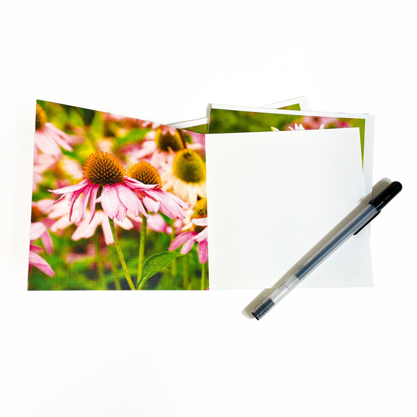 Blooming from early summer until early fall, fragrant pink lilies are as eye-catching, and equally elegant, as Mackinac's Victorian cottages.  Inside the card is an image of pink coneflowers thriving along with the lilies in a cottage garden.  Photography by Jennifer Wohletz. 